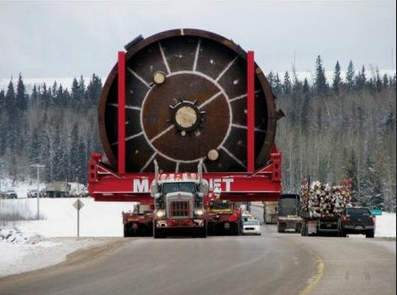Yes, that's a full-sized log truck to the right of this Exxon-Mobile megaloaded carrying Korean-made tar sands mining equipment bound for the Alberta tar sands oil fields over Lolo Pass and along the Wild and Scenic Lochsa River in Idaho.